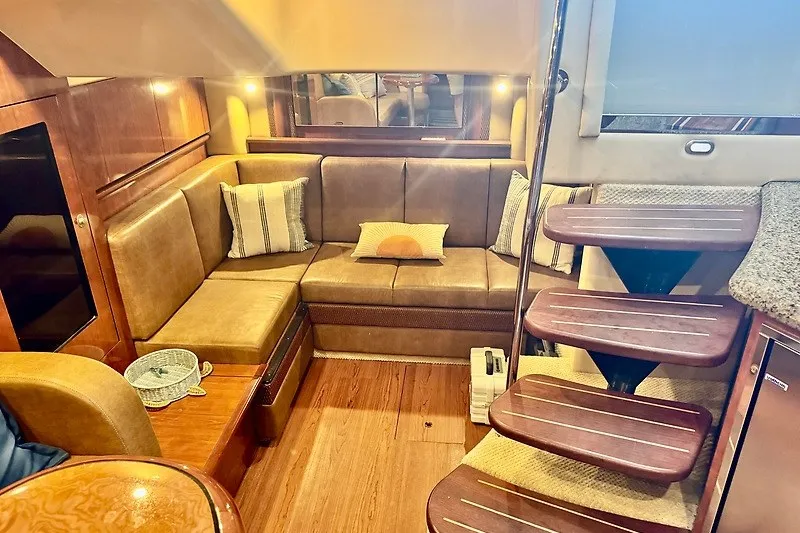 Slide: The Image of Luxurious interior of 2005 Sea Ray 390 Sundancer yacht with cozy seating and elegant wood finishes. - 17