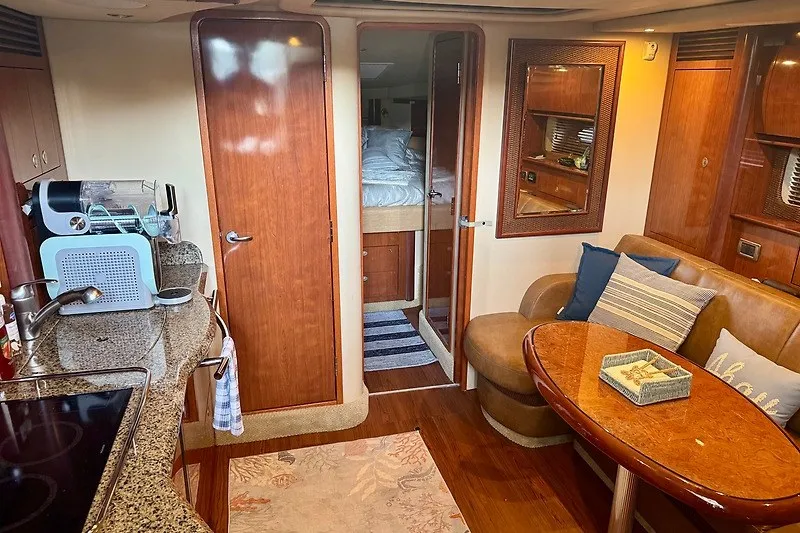 Slide: The Image of Luxurious interior of a 2005 Sea Ray 390 Sundancer yacht with cozy seating and modern amenities. - 11