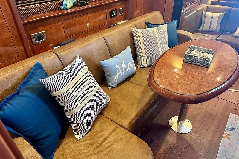 Slide: The Image of Luxurious interior of 2005 Sea Ray 390 Sundancer with plush seating and decorative pillows. - 12