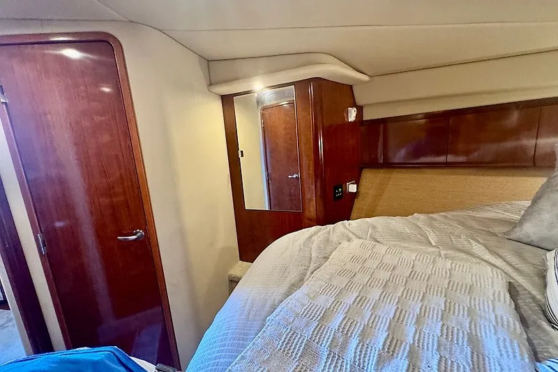 Slide: The Image of Luxurious cabin interior of 2005 Sea Ray 390 Sundancer yacht with wood finishes. - 13