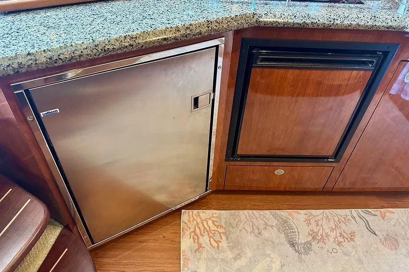 Slide: The Image of 2005 Sea Ray 390 Sundancer galley with stainless steel appliances and granite countertop. - 9