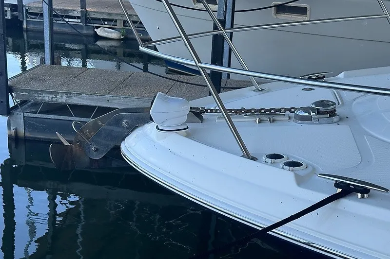 Slide: The Image of 2005 Sea Ray 390 Sundancer yacht docked, showing anchor and deck details. - 19