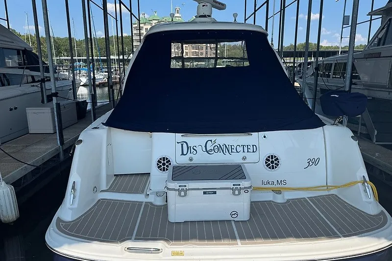 Slide: The Image of 2005 Sea Ray 390 Sundancer docked, rear view with covered cockpit and cooler. - 30