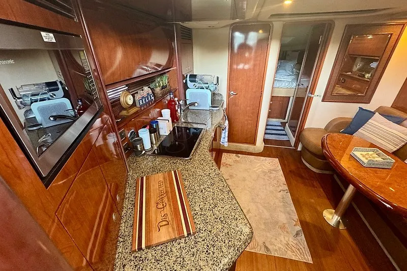 Slide: The Image of Luxurious interior of 2005 Sea Ray 390 Sundancer yacht with modern kitchen and cozy seating area. - 6