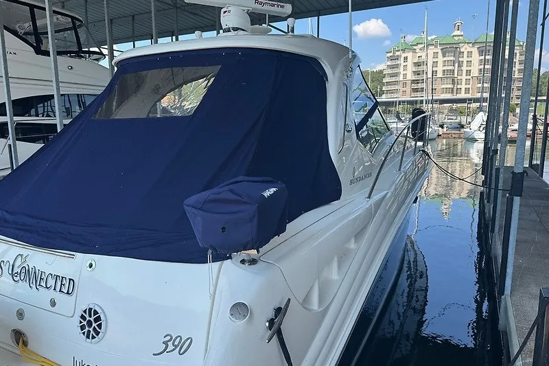 Slide: The Image of 2005 Sea Ray 390 Sundancer yacht docked in marina with blue cover. - 29