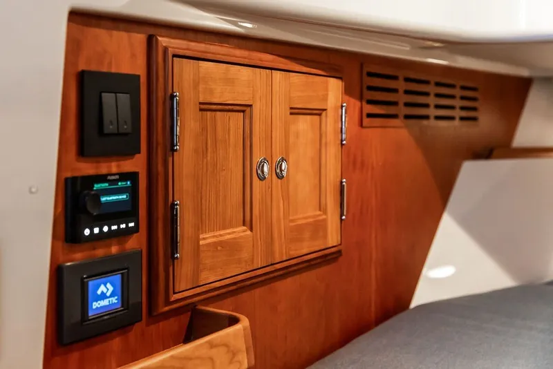 Slide: The Image of Interior of 2026 Hinckley Picnic Boat 39, featuring wooden cabinetry and control panels. - 29