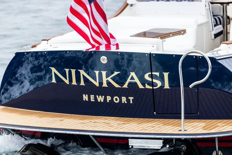 Slide: The Image of 2026 Hinckley Picnic Boat 39, named "Ninkasi," with American flag, docked in Newport. - 5