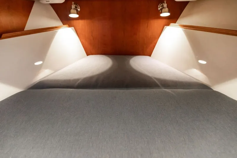 Slide: The Image of Interior cabin of 2026 Hinckley Picnic Boat 39 with cozy lighting and modern design. - 30