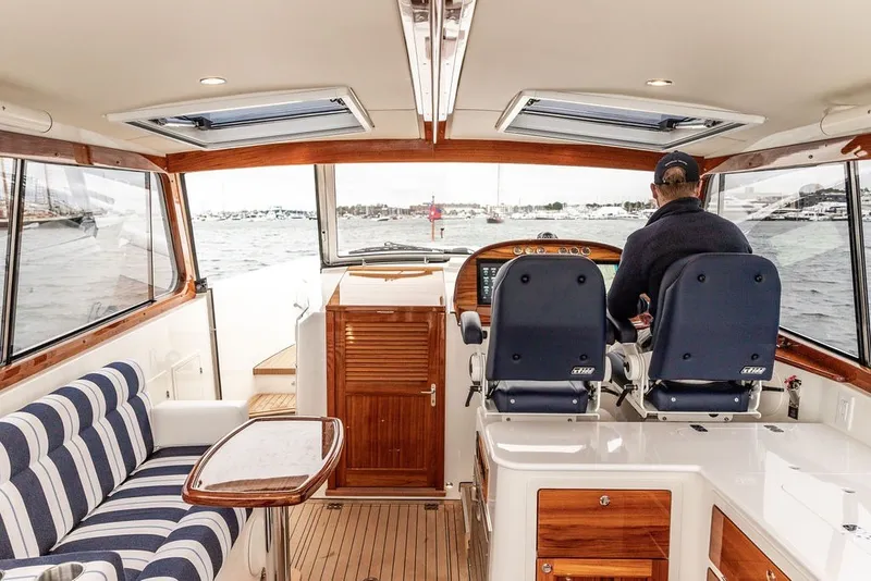 Slide: The Image of Interior of 2026 Hinckley Picnic Boat 39, featuring elegant seating and modern helm controls. - 9