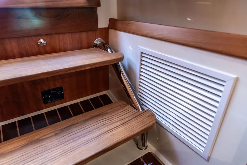 Slide: The Image of Interior of 2026 Hinckley Picnic Boat 39, featuring wooden steps and a vent. - 27