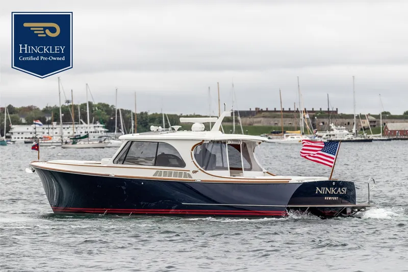 The Image of 2026 Hinckley Picnic Boat 39 on the water with an American flag. - 0