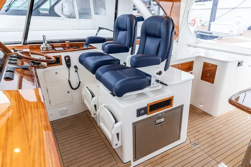 Slide: The Image of Interior of 2026 Hinckley Picnic Boat 39 with luxurious seating and wooden accents. - 24