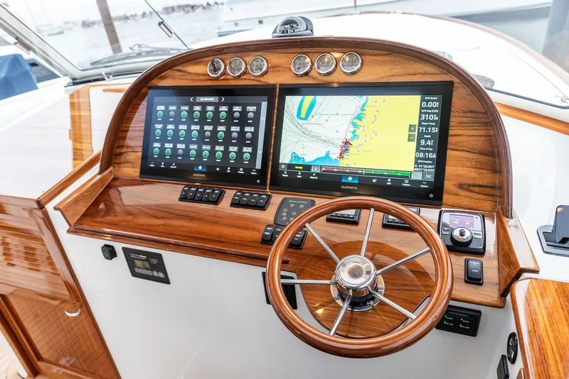Slide: The Image of Helm of 2026 Hinckley Picnic Boat 39 with advanced navigation displays and controls. - 25
