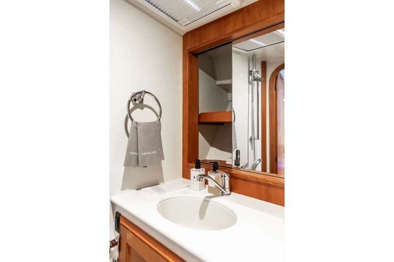 Slide: The Image of Elegant bathroom interior of 2026 Hinckley Picnic Boat 39, featuring modern sink and mirror. - 34