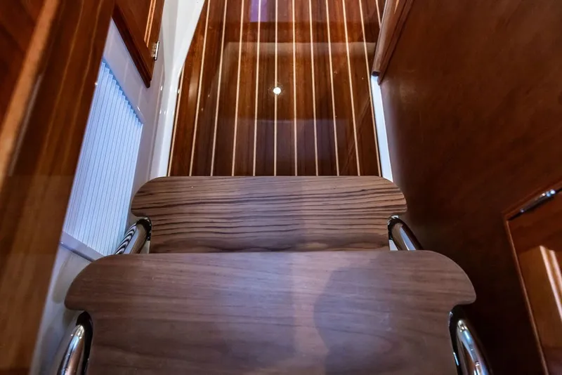 Slide: The Image of Wooden interior stairs of 2026 Hinckley Picnic Boat 39, showcasing elegant craftsmanship. - 26