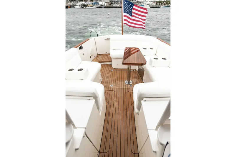 Slide: The Image of 2026 Hinckley Picnic Boat 39 with elegant teak deck and American flag. - 7