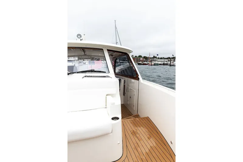 Slide: The Image of 2026 Hinckley Picnic Boat 39 with teak deck, docked in a marina. - 20