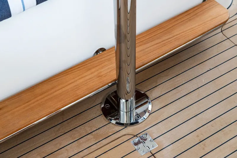 Slide: The Image of Hinckley Picnic Boat 39 (2026) features elegant teak decking and polished metal details. - 16