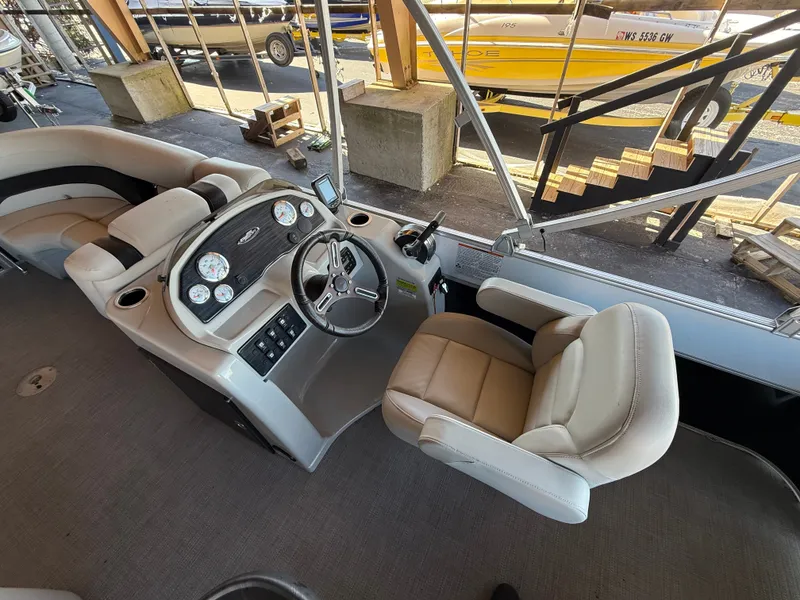 Slide: The Image of The image shows the cockpit of a 2017 Starcraft EX 20 C with a beige captain's chair and modern dashboard. - 11