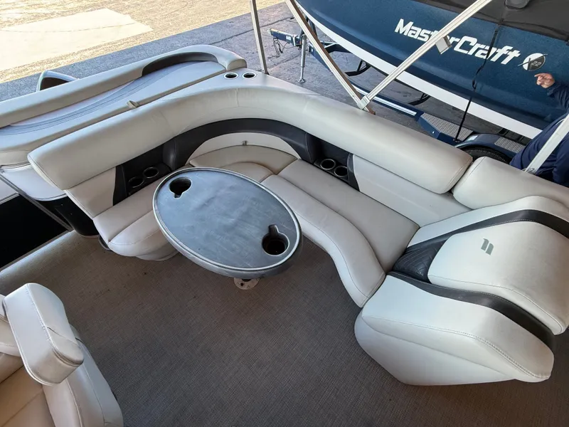 Slide: The Image of Interior view of a 2017 Starcraft EX 20 C with curved white seating and a round table. - 10