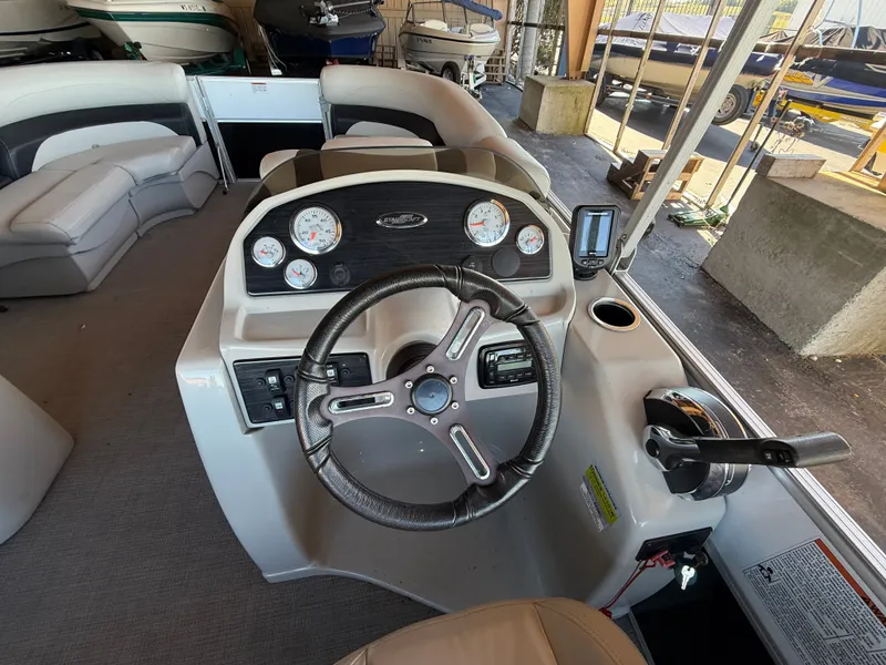 Slide: The Image of The image shows the helm of a 2017 Starcraft EX 20 C with various instruments. - 12