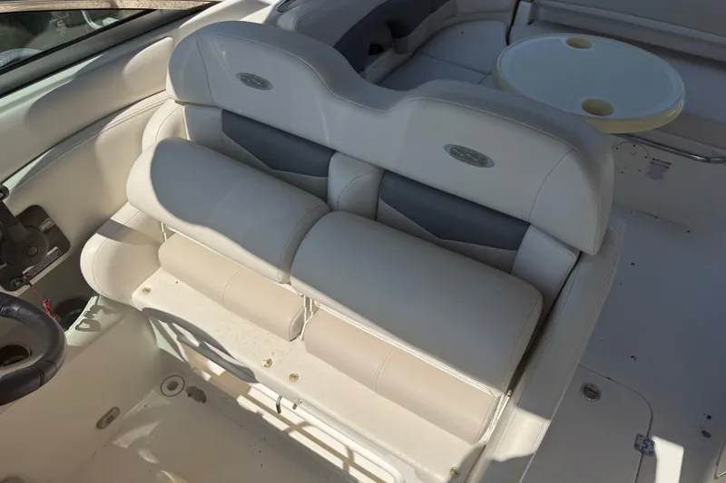 Slide: The Image of 2007 Chaparral 275 SSi boat interior with white seating and round table. - 9