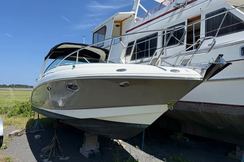 Slide: The Image of 2007 Chaparral 275 SSi boat on stands, parked outdoors under clear blue sky. - 2