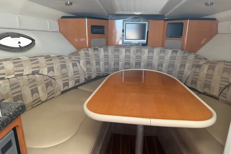 Slide: The Image of Interior of a 2007 Chaparral 275 SSi boat with a cozy dining area and TV. - 13