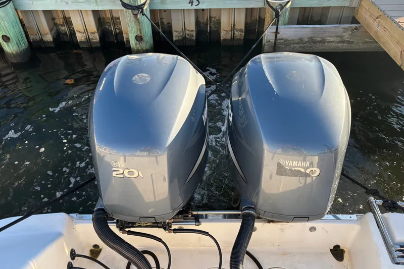 Slide: The Image of Twin Yamaha outboard engines on a 2004 Robalo R245 Walkaround boat at dock. - 35