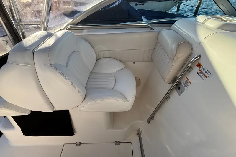 Slide: The Image of 2004 Robalo R245 Walkaround boat interior with white cushioned seating. - 23