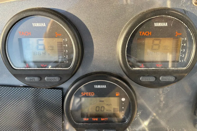 Slide: The Image of Yamaha gauges on a 2004 Robalo R245 Walkaround boat dashboard. - 37
