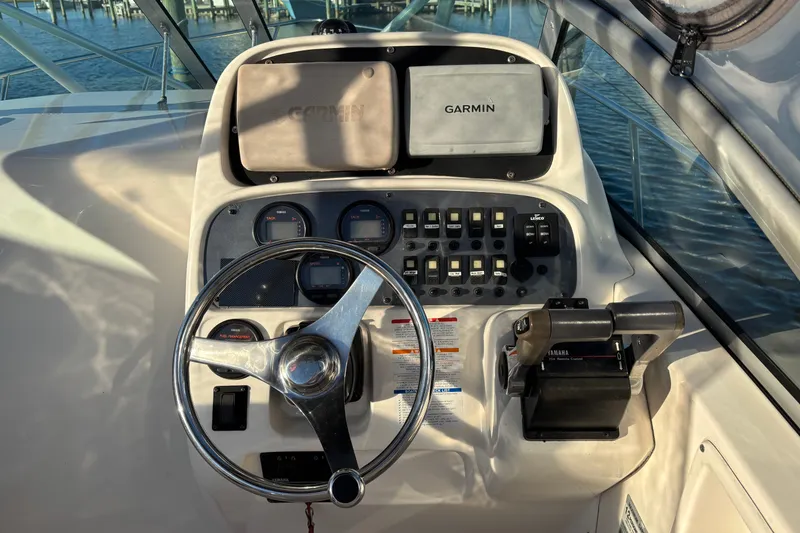 Slide: The Image of 2004 Robalo R245 Walkaround helm with Garmin navigation and Yamaha throttle controls. - 8