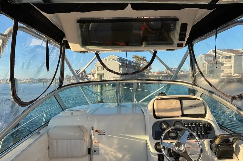 Slide: The Image of 2004 Robalo R245 Walkaround boat interior with steering wheel and navigation equipment. - 6
