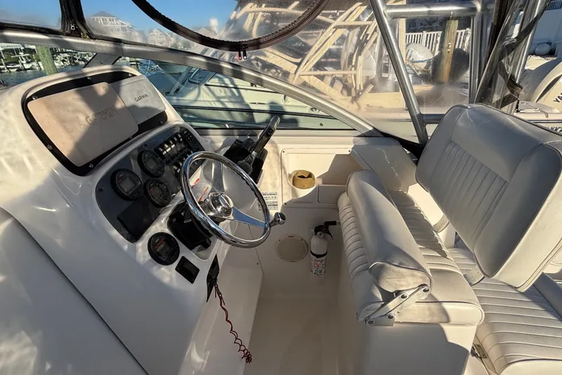 Slide: The Image of 2004 Robalo R245 Walkaround boat interior with steering wheel and seating. - 9