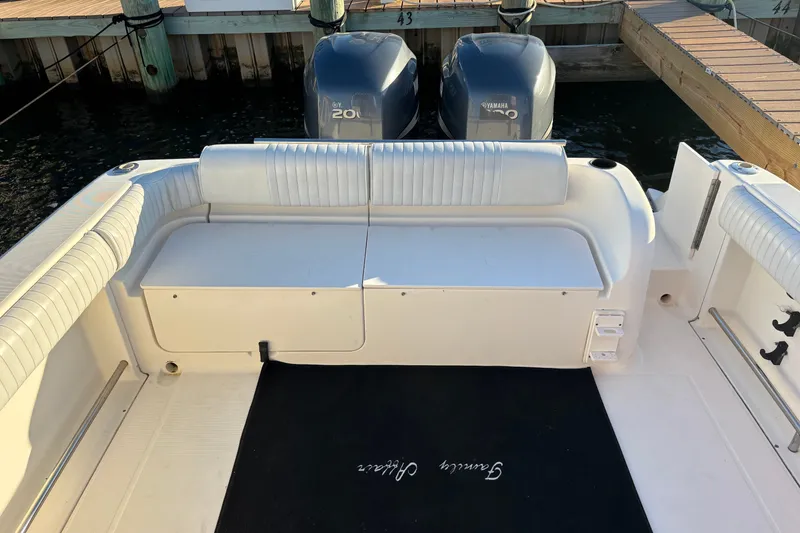 Slide: The Image of 2004 Robalo R245 Walkaround boat interior with Yamaha engines at dock. - 27