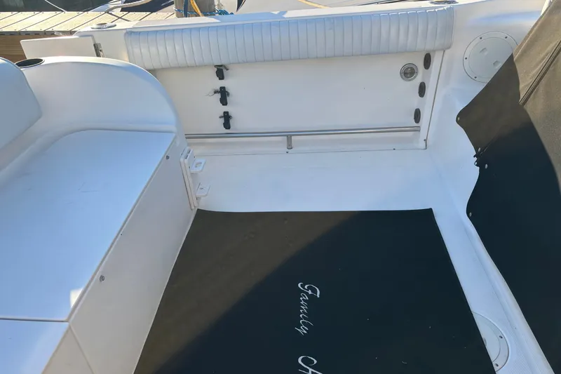 Slide: The Image of 2004 Robalo R245 Walkaround boat interior with seating and storage area. - 31
