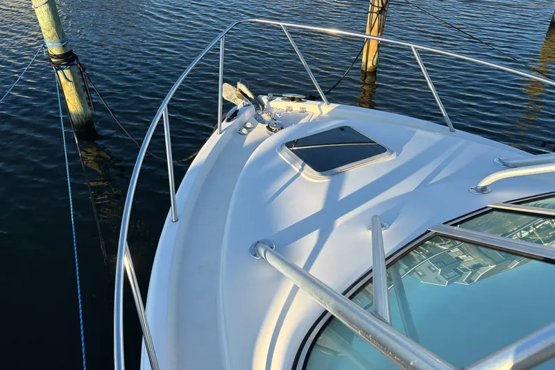 Slide: The Image of 2004 Robalo R245 Walkaround boat deck with railing and water view. - 5