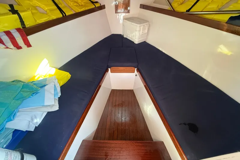 Slide: The Image of 1970 Prowler 32 Forest Johnson cabin interior with blue cushions and life jackets. - 15