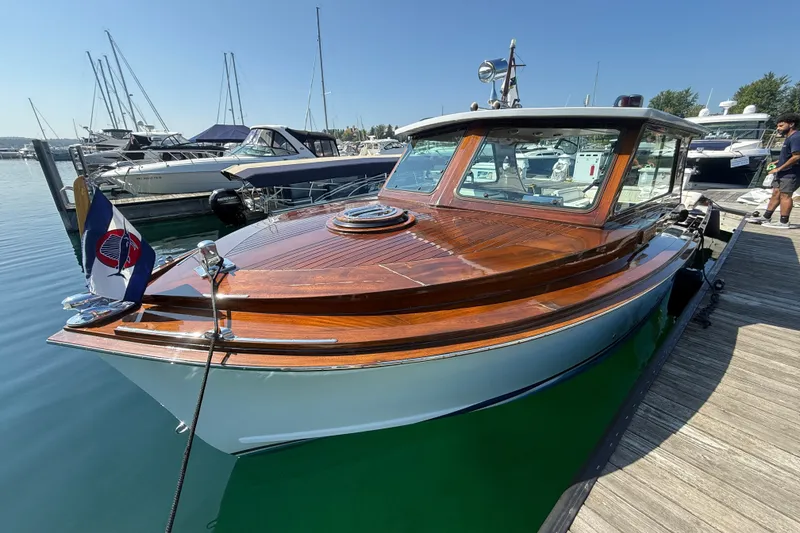 The Image of 1970 Prowler 32 Forest Johnson boat docked, showcasing polished wood and classic design. - 1