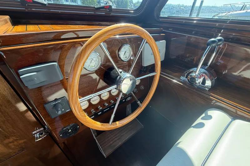 Slide: The Image of Vintage 1970 Prowler boat dashboard with wooden steering wheel and classic gauges. - 14