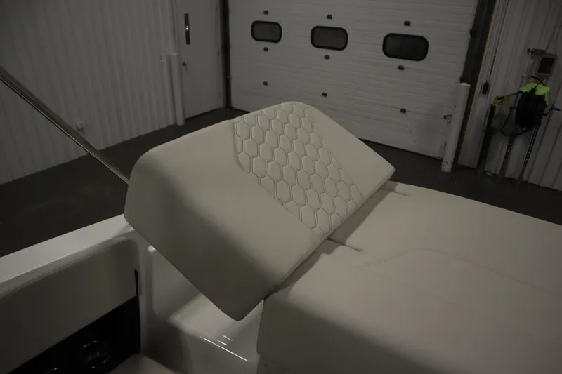 Slide: The Image of 2026 Four Winns H1 boat interior with hexagonal-patterned upholstery in a garage setting. - 34
