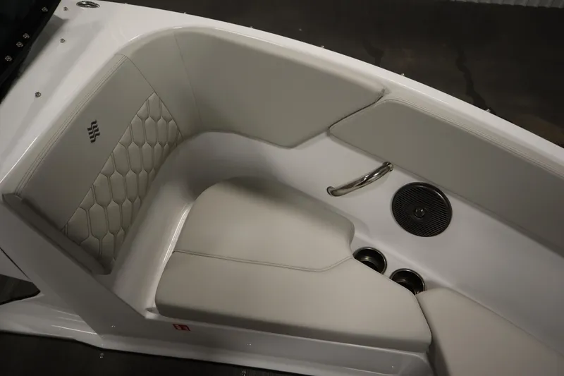Slide: The Image of 2026 Four Winns H1 boat interior with white cushioned seating and speaker. - 12