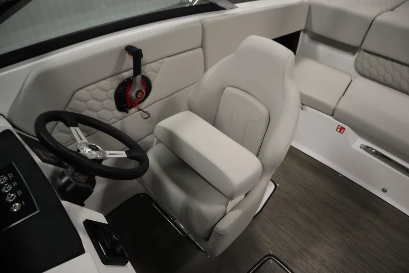 Slide: The Image of 2026 Four Winns H1 boat interior with steering wheel and cushioned seating. - 24