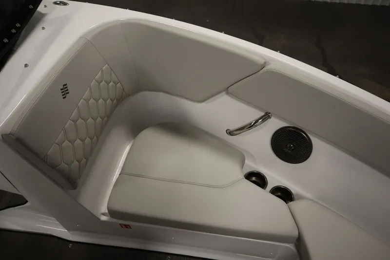 Slide: The Image of 2026 Four Winns H1 boat interior with white cushioned seating and speaker. - 49