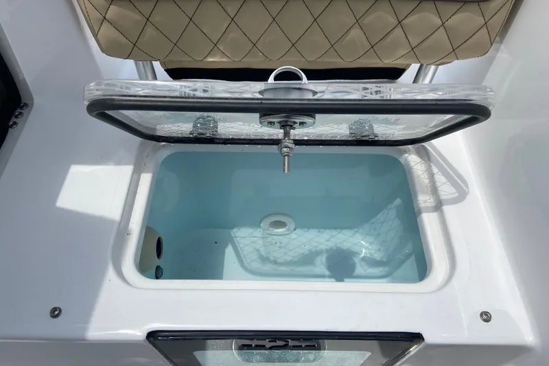 Slide: The Image of Livewell compartment on 2027 Sportsman Heritage 231 Center Console boat, open lid view. - 8