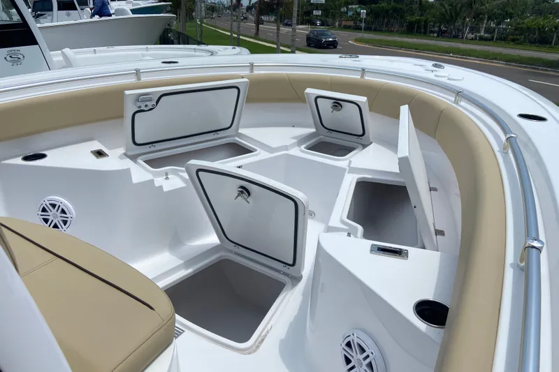 Slide: The Image of 2027 Sportsman Heritage 231 Center Console boat with open storage compartments and seating. - 22