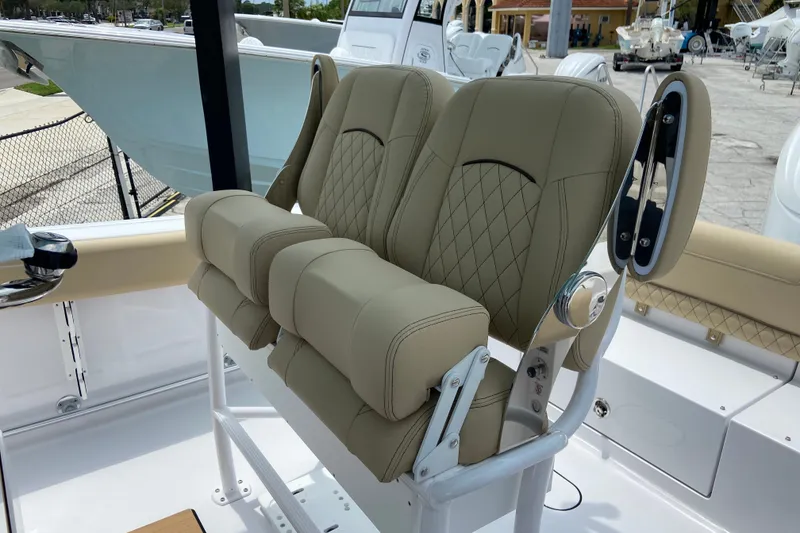 Slide: The Image of 2027 Sportsman Heritage 231 Center Console boat with beige cushioned seating. - 14