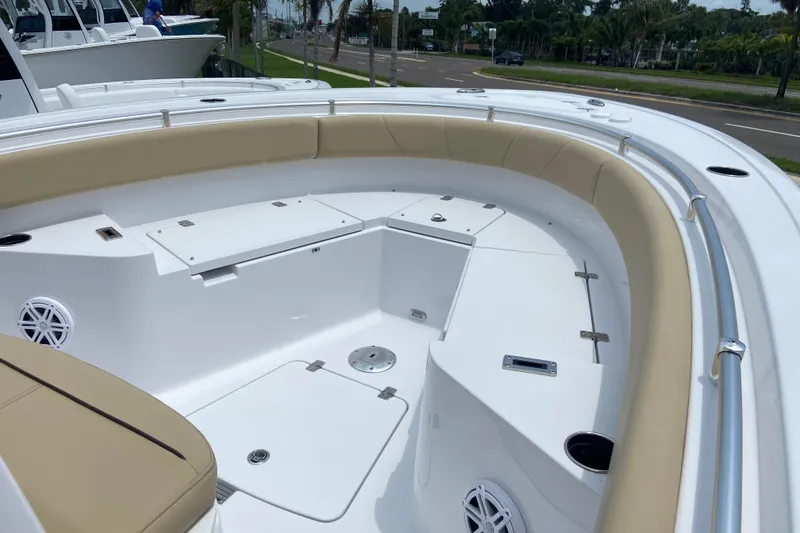Slide: The Image of 2027 Sportsman Heritage 231 Center Console boat interior with cushioned seating and storage compartments. - 20