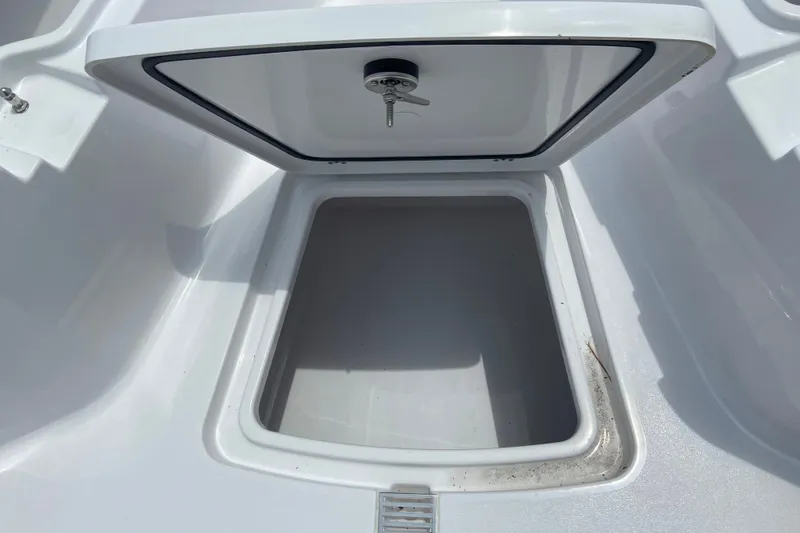 Slide: The Image of Open storage compartment on 2027 Sportsman Heritage 231 Center Console boat. - 23