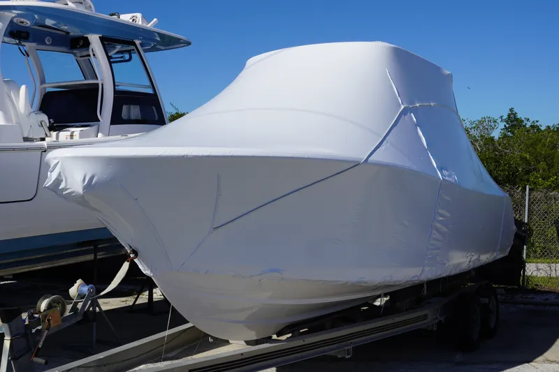 The Image of 2027 Sportsman Heritage 231 Center Console boat covered in protective wrap on trailer. - 0